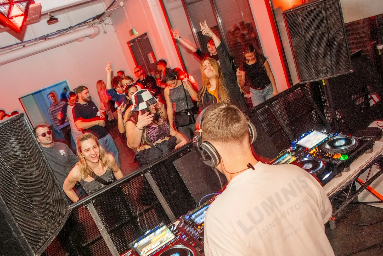 A group of people in a room with dj equipment