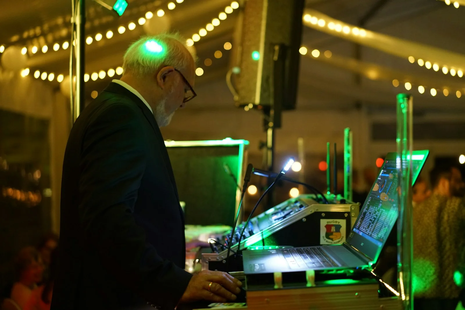 man wearing black blazer using laptop