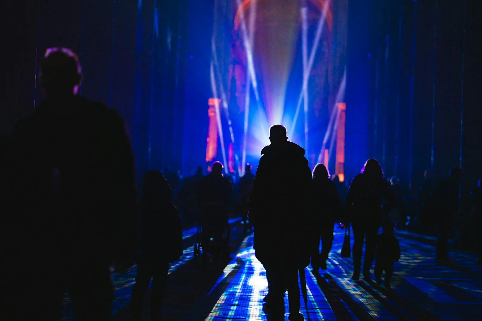 a group of people standing around a stage a group of people standing around a stage