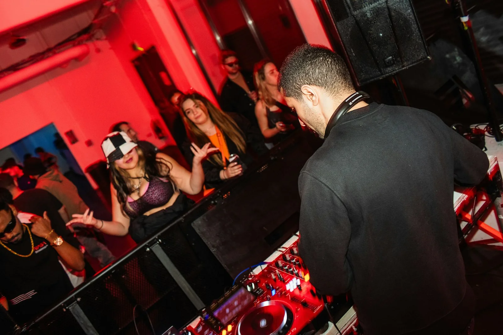 A dj mixing at a party with a crowd of people A dj mixing at a party with a crowd of people