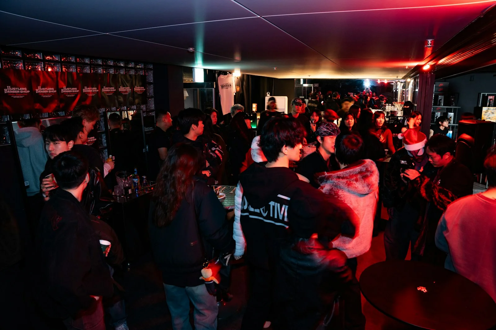 Crowd of people gathered in a dimly lit club Crowd of people gathered in a dimly lit club